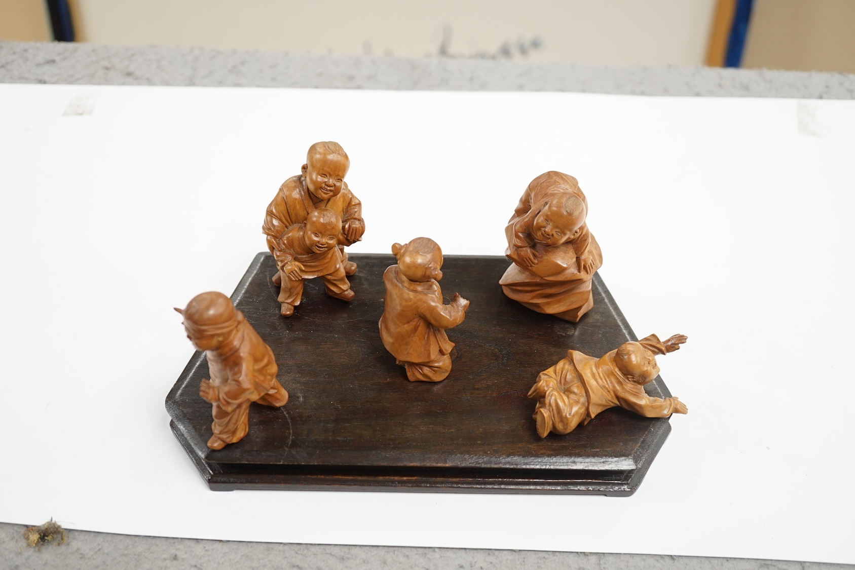 A set five Chinese carved boxwood figures of children playing Blind man’s Buff, Republic period, 23cm wide. Condition - good